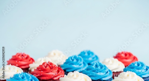Colorful patriotic cupcakes with white frosting and blue red swirls