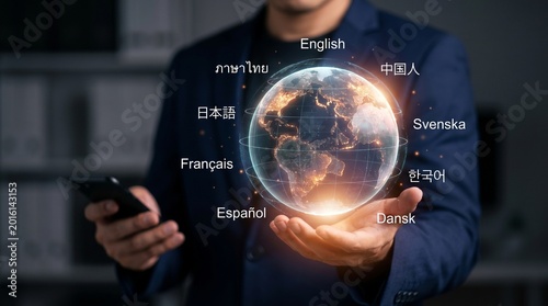 Businessman holding a glowing digital globe with various language labels representing global communication and international business connectivity