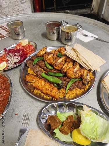 Authentic Turkish dining experience in Istanbul featuring grilled meat skewers, traditional Turkish tea, and rich local cuisine served in a cozy restaurant atmosphere.