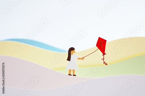 Minimal girl flying red kite in abstract pastel landscape
