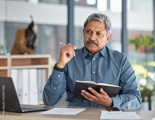 Older man thinking at desk