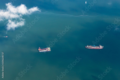 Bild auf Leinwand An aerial, top-down view captures a large dredging vessel and a tanker ship navigating the blue ocean