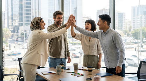 Diverse Corporate Team Giving High Five in Modern Office Meeting