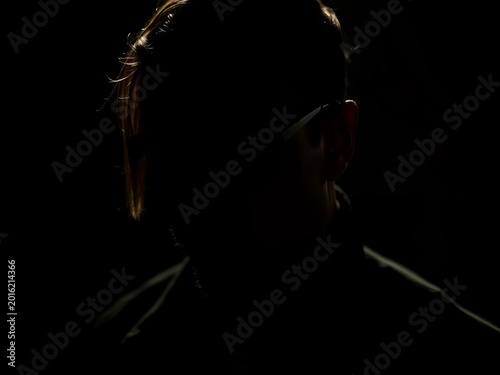 Shadows dance on determined features, a silent pursuit of power in the dim light,  chiaroscuro,  ambition