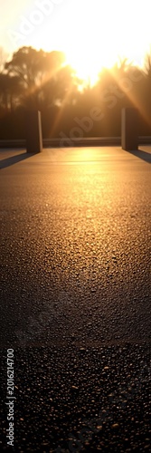 Subtle sheen on dark, textured asphalt, a grounding stage under diffused glow, asphalt,  background