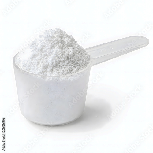 White powdered substance in clear measuring cup on white background  