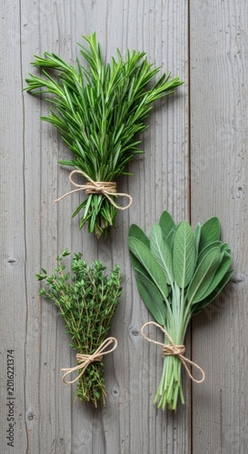 Fresh herbs, rosemary, thyme, oregano bunches on rustic wood