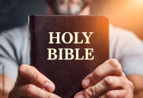 Person holding holy bible offering christian faith