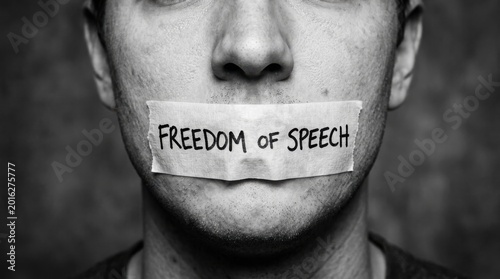 m Freedom of speech concept with tape over mouth, censored man with freedom of speech text, human rights and censorship protest in black and white