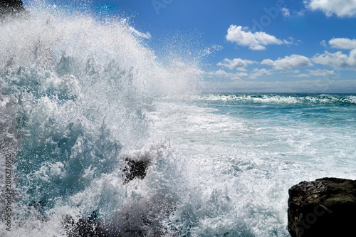 Atlantic waves crash powerfully against black lava rocks along the coast of Ajuy on Fuerteventura