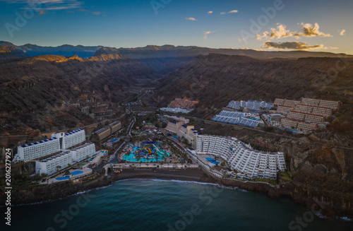 Gran Canaria, Spain - March 2026 - Taurito aerial panoramic view at sunrise, Luxury Resorts and Water Park on Volcanic Cliffs, Gran Canaria, Spain.