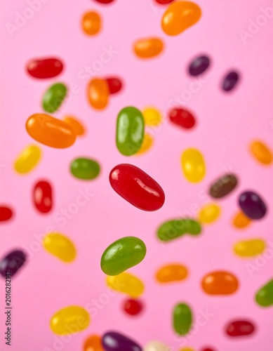Colorful Assorted Jelly Beans Falling In Mid Air Against A Vibrant Pink Background Glossy Candy Sweets Floating In Motion With Shallow Depth Of Field