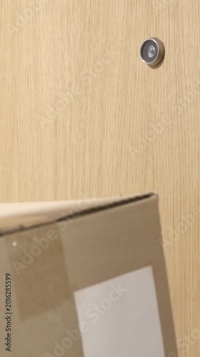 Delivery direct to your door.Photo of a courier delivering a box to a customer and knocking on the door inside a building
