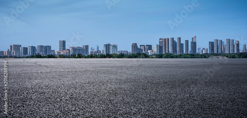 Breathtaking Urban Skyline with Expansive Dry Landscape in the Foreground