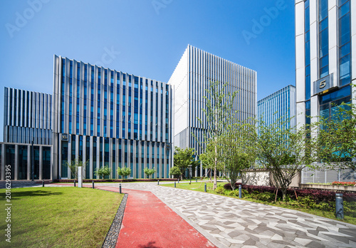 Stunning Modern Office Complex Surrounded by Lush Greenery and Clear Blue Skies