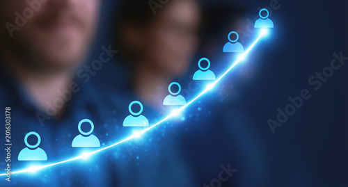 Glowing human icons rising in an upward curve, representing longer life expectancy, population growth, healthcare progress and demographic trends. Selective focus.
