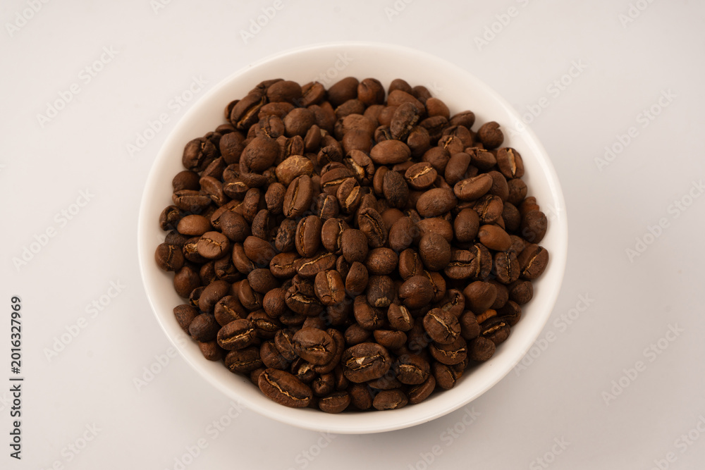 Fototapeta premium Coffee beans on a white background. Top view. Coffee beans texture.