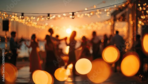 Silhouettes of people dancing under string lights at sunset.