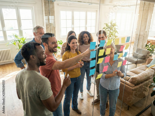 Diverse Team Collaborating On Sticky Note Brainstorming Session In Modern Office Meeting
