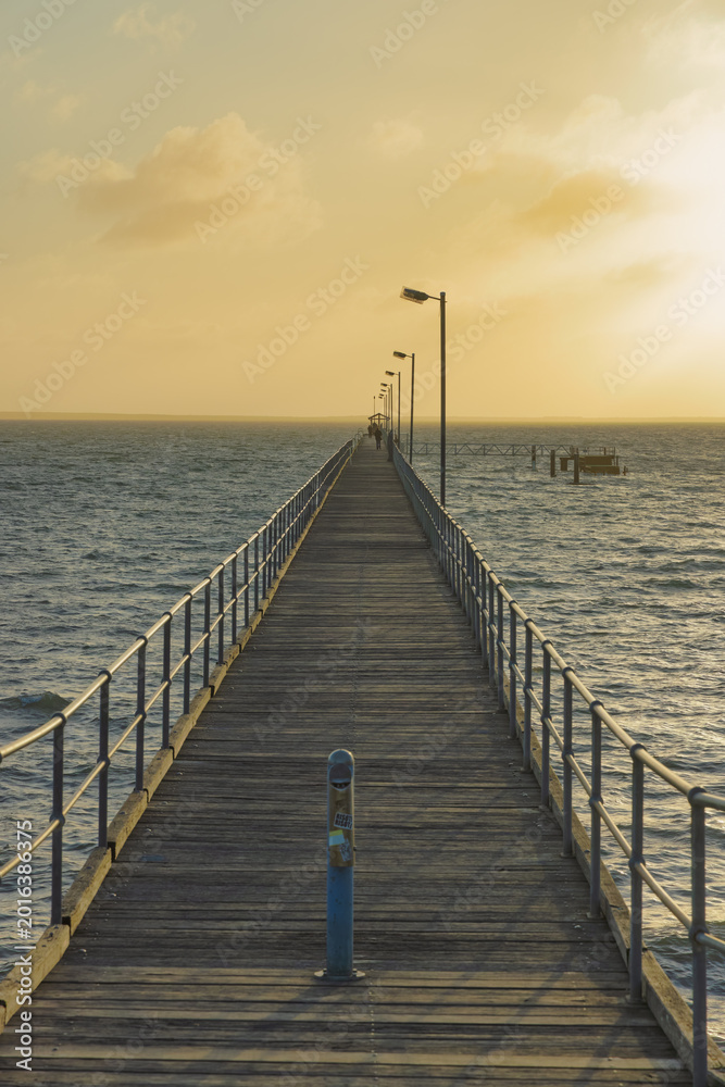 Fototapeta premium Pier extending into the ocean at Ceduna, Australia during sunset