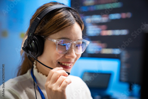 Asian woman wearing headset working as customer support agent
