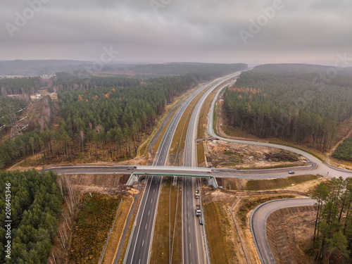 Fotografie Beautiful landscape of a highway running through a forest in Poland