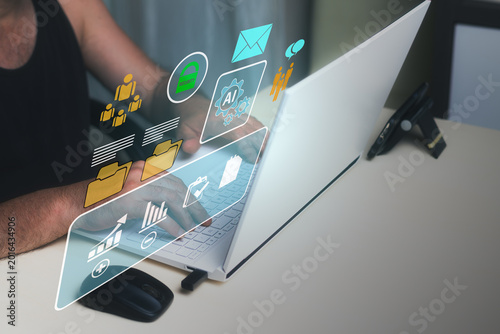 Businessman working with artificial intelligence technology, managing data and statistics, filling out forms and company documents on a laptop at home. Business technology concept for success.