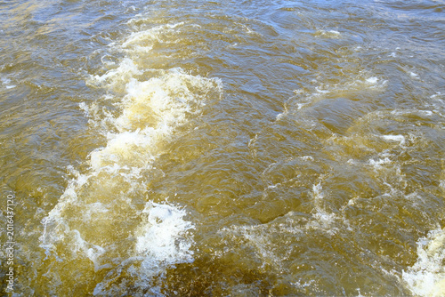Billede på lærred Closeup of foamy boat wake on river water with splashing waves, turbulent surfac