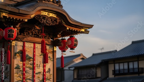 Traditional Gion Matsuri festival float with decorated ornate carvings and red lanterns against city rooftops for Japanese heritage and cultural tourism concept