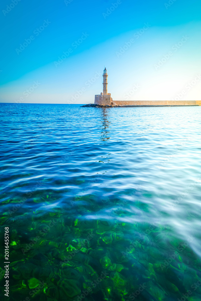 Fototapeta premium bay of Chania with sea and lighthouse at sunny summer sunset, Crete, Greece, web banner format