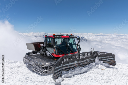Bild auf Leinwand Snowcat parked on a high alpine ridge above a sea of clouds on Mount Elbrus, Kab