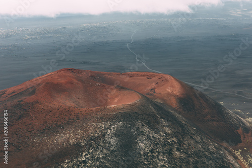 Fényképezés Aerial landscape of a volcanic crater with red scoria slopes and dark lava field