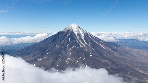 Photos Aerial landscape of Koryaksky volcano rising above a sea of clouds on the Kamcha