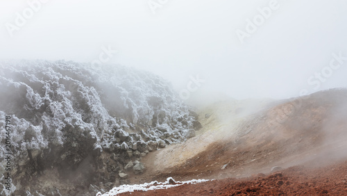 Photos Steaming volcanic crater with snow-covered rocks and red ash slopes in Avachinsk