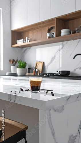 A modern kitchen with marble countertops and white cabinets