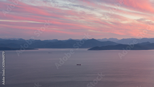 Bild auf Leinwand Wide seascape view of Avacha Bay at sunset with pink clouds, calm water and carg