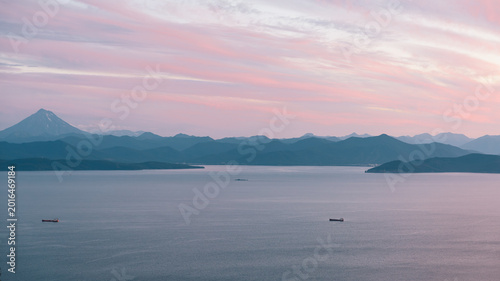 Fényképezés Wide view of Avacha Bay with calm sea, distant cargo ships and layered mountain