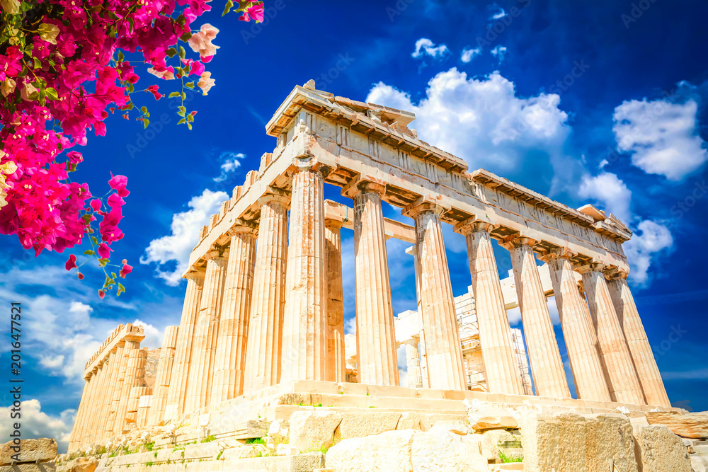 Fototapeta premium Parthenon temple over bright blue summer sky background with flowers, Acropolis hill, Athens Greece