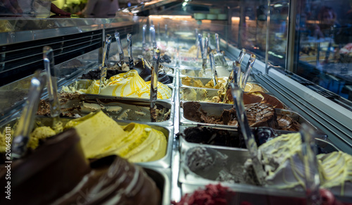 Obraz na plátně Colorful artisan gelato flavors displayed in illuminated ice cream counter