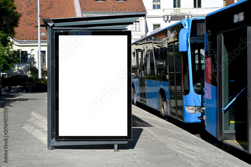 blank poster sign panel bus shelter. billboard mockup display. white lightbox sign in bus stop. digital panel. city transit station. urban street. park setting. outdoor advertising
