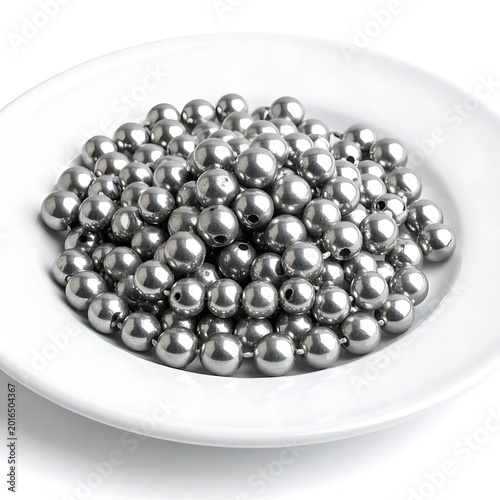 A white plate filled with numerous small, shiny silver balls
