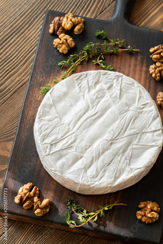 Camembert Cheese Garnished With Fresh Thyme And Walnuts Rustic Gourmet Presentation