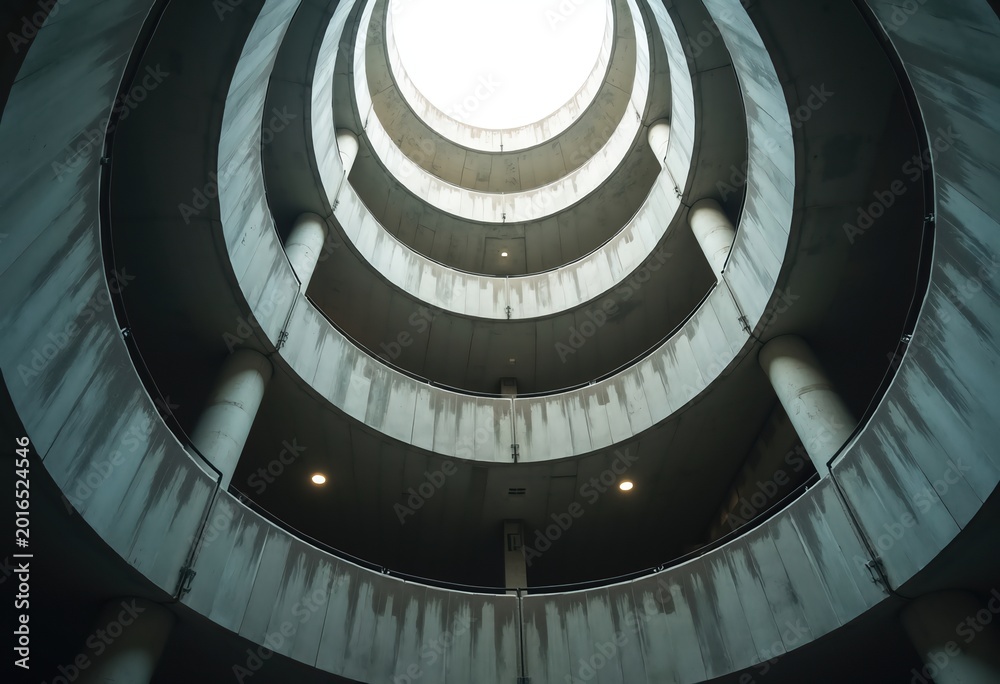 Fototapeta premium Spiraling Brutalist Concrete Parking Structure Architectural Photography Dramatic Angles Monolithic Formations