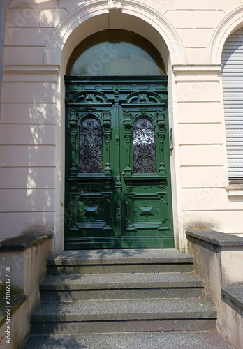 Traditional German Door with Carved Panels and Wrought Iron Details