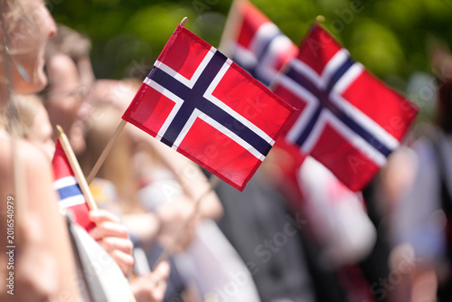 Joyful Crowd Waving Small Norwegian Flags During Patriotic Constitution Day Celebration Parade