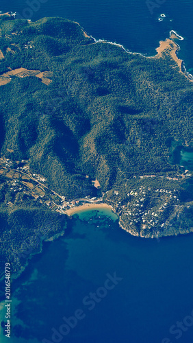 Vertical aerial view of Fuengirola coastline and Mediterranean Sea from airplane window