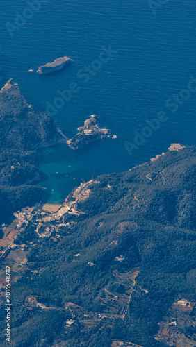 Aerial view of Ibiza Island coastline from commercial airplane window 4K