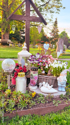 Memorial altar with flowers and candles during cemetery remembrance ceremony season, symbolic spiritual tribute installation expressing cultural funeral traditions, peaceful reflection and respectful