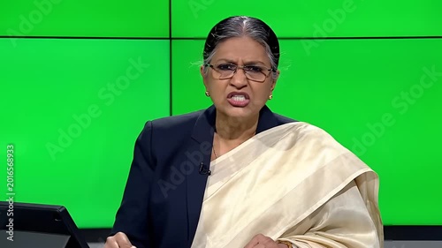 Elderly Indian Woman Speaking Passionately in a Studio Setting.