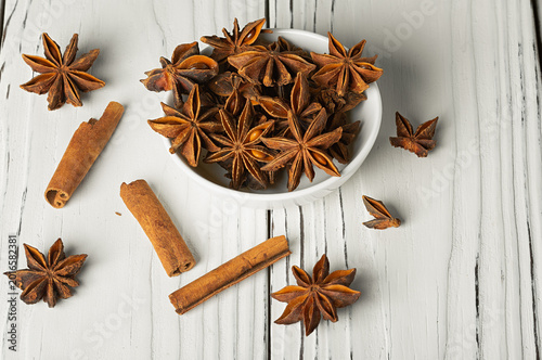 Fotografi Star anise, or badian, is a star-shaped fruit with seeds inside, on a white background